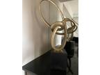 art deco piece Golden knot on a black pedestal. 29 inches tall.