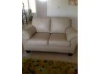 Matching leather love seats . Light color