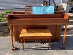 Piano with bench and music books