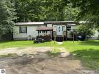 Cadillac, Four bedroom, two bath manufactured home outside .