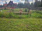 Antique horse drawn hay dump rake